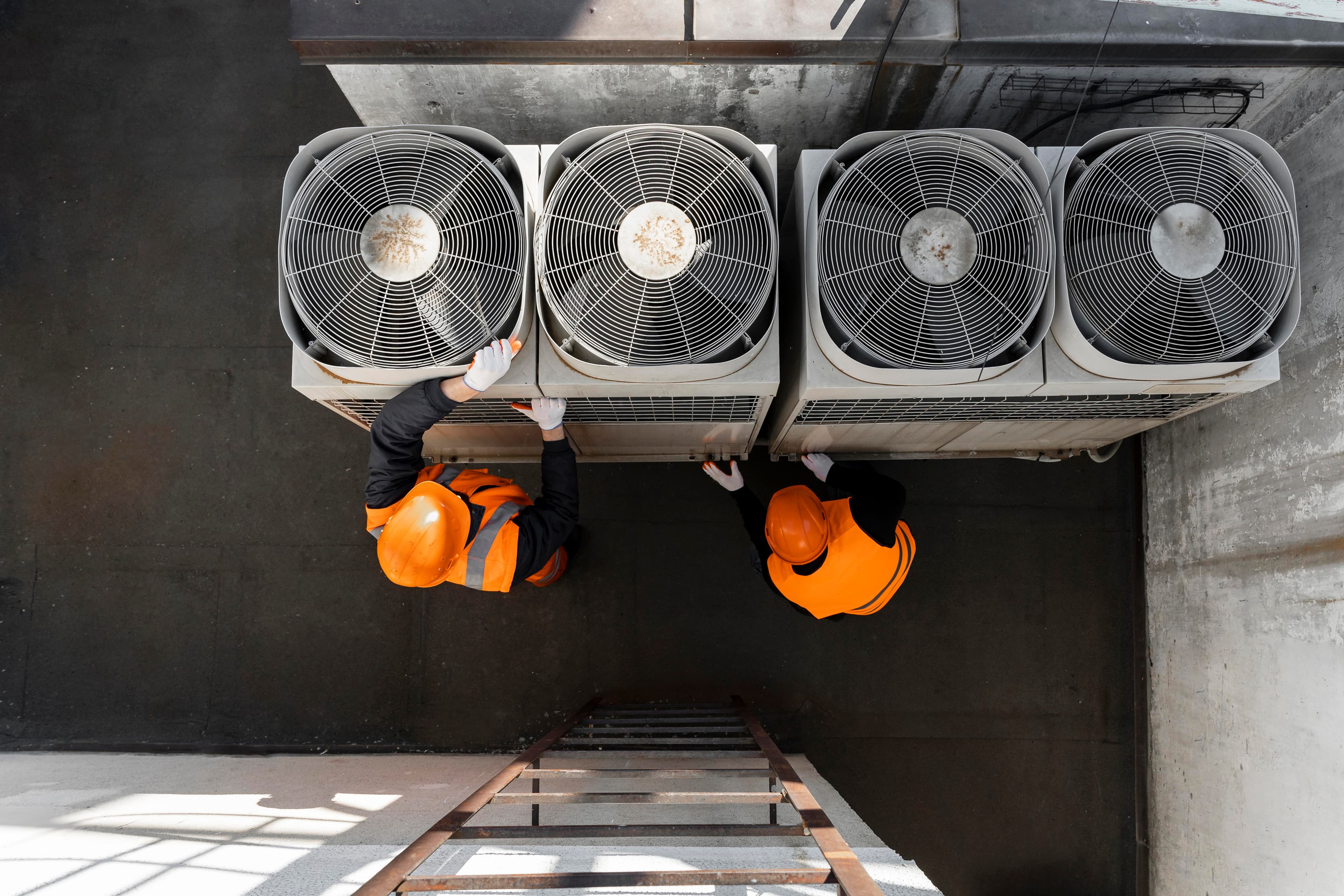 HVAC technicians servicing commercial cooling units